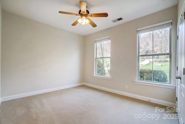 empty room with visible vents, baseboards, and a wealth of natural light