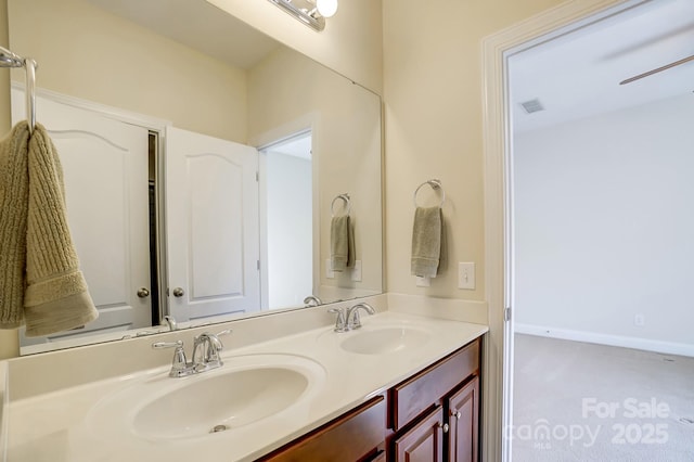 full bathroom featuring double vanity, baseboards, visible vents, and a sink