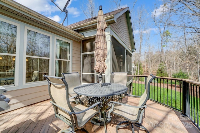 wooden deck with a sunroom