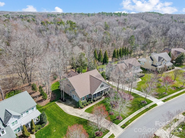 drone / aerial view featuring a wooded view