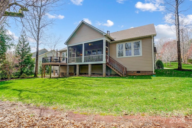 back of house featuring a lawn, a sunroom, stairway, crawl space, and a deck