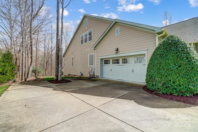 view of property exterior with a garage, concrete driveway, and crawl space