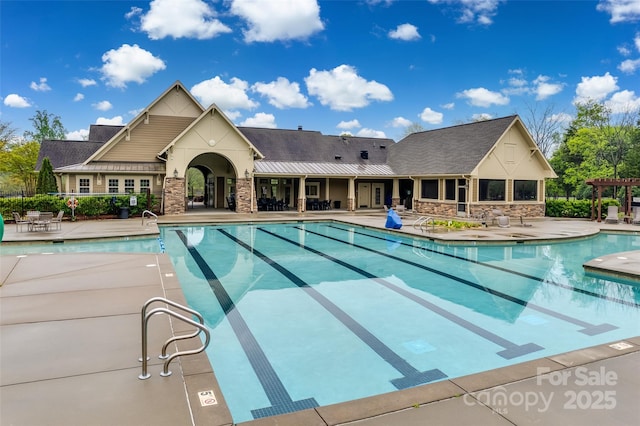 community pool with fence and a patio