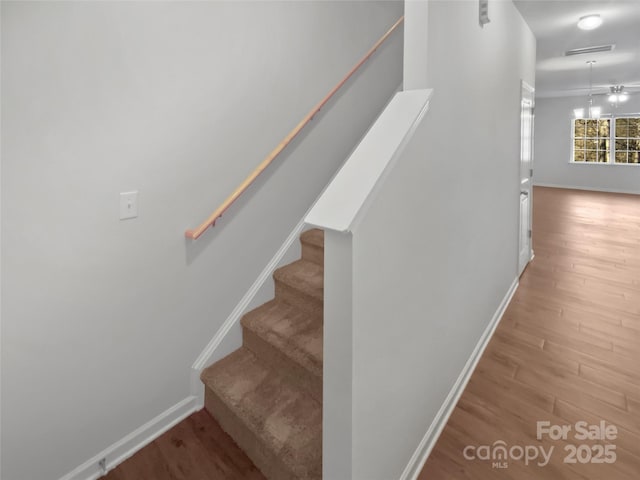 stairs with baseboards and wood finished floors