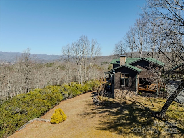 exterior space with a mountain view and a chimney