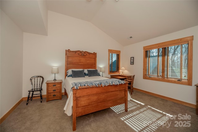 carpeted bedroom featuring lofted ceiling and baseboards