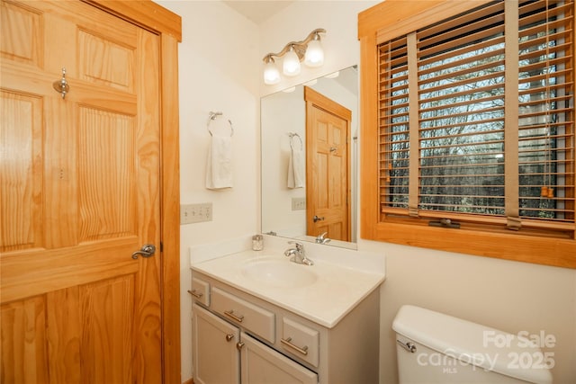 half bathroom with toilet and vanity