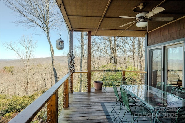 deck featuring outdoor dining area and ceiling fan