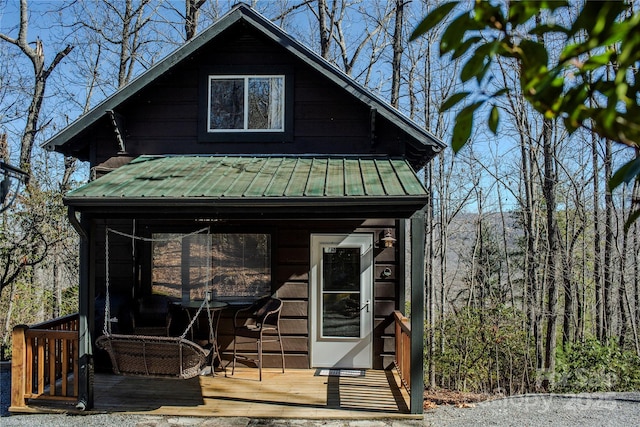 view of front of home featuring an outbuilding and metal roof