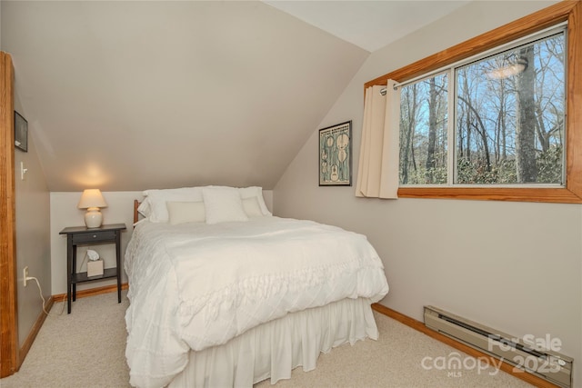 carpeted bedroom with a baseboard heating unit, baseboards, and vaulted ceiling