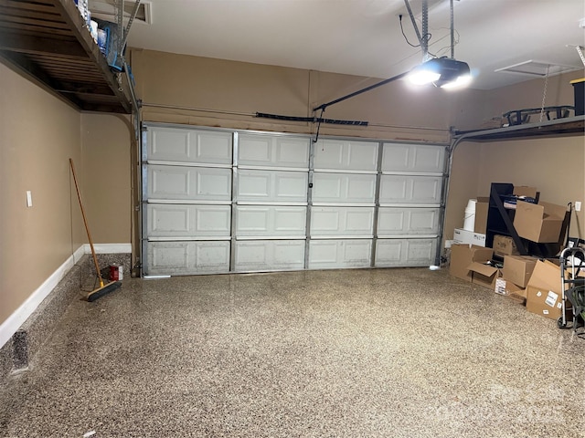 garage with a garage door opener and baseboards