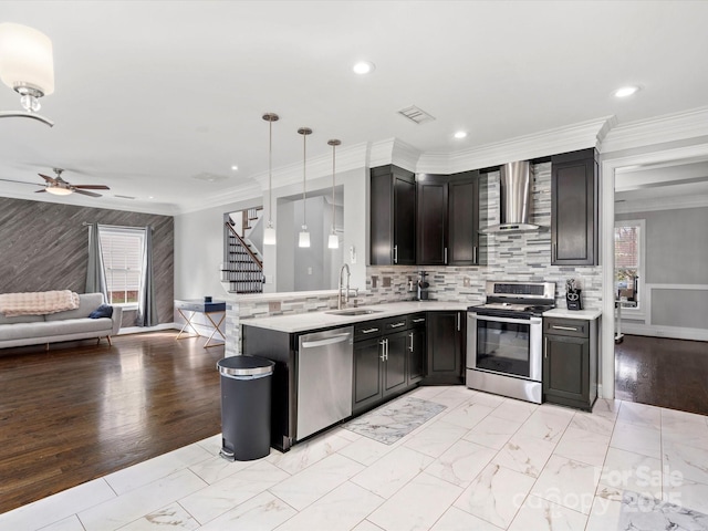 kitchen with marble finish floor, visible vents, appliances with stainless steel finishes, a sink, and wall chimney exhaust hood