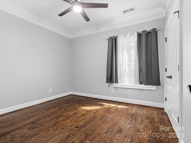 spare room featuring baseboards, visible vents, ceiling fan, ornamental molding, and dark wood-type flooring