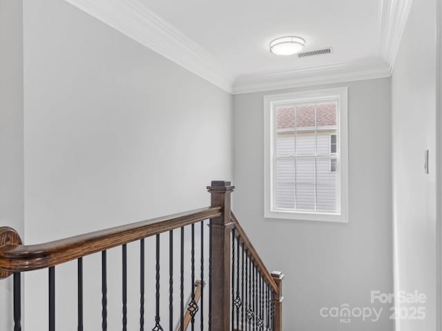 stairs featuring visible vents and crown molding