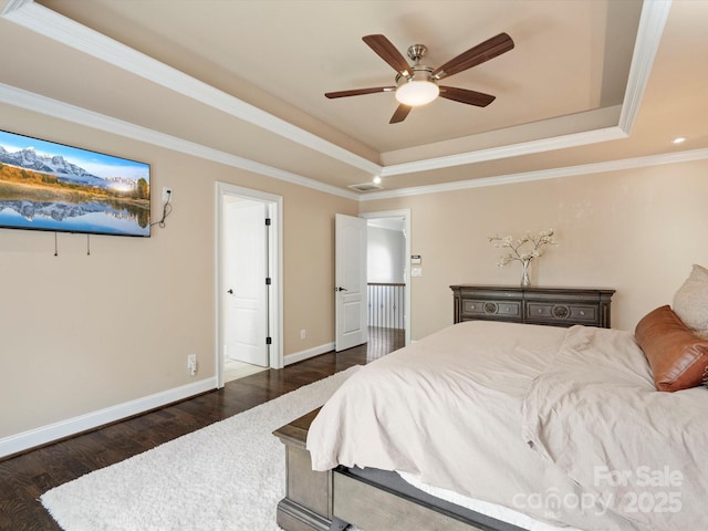 bedroom featuring a tray ceiling, dark wood-style flooring, visible vents, ornamental molding, and baseboards