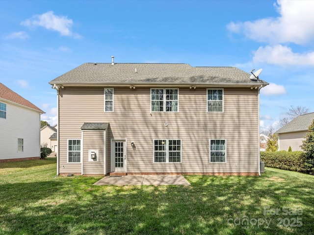 back of house with a patio and a lawn