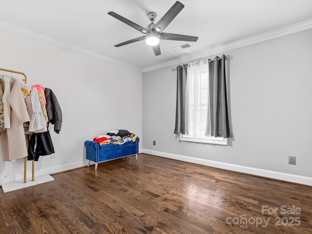 bedroom featuring crown molding, baseboards, and wood finished floors