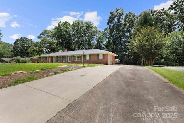 1210 Brookwood Dr, Shelby, NC 28150 - ranch-style home featuring driveway, brick siding, a front lawn, and a chimney