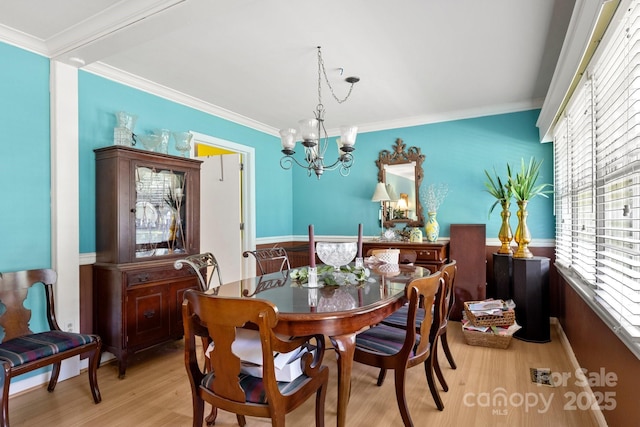1210 Brookwood Dr, Shelby, NC 28150 - dining space featuring wood finished floors, a chandelier, plenty of natural light, and ornamental molding