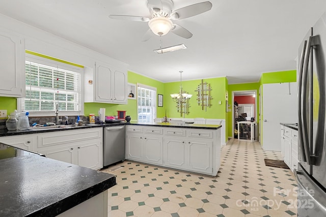 1210 Brookwood Dr, Shelby, NC 28150 - kitchen with appliances with stainless steel finishes, a peninsula, light flooring, and dark countertops