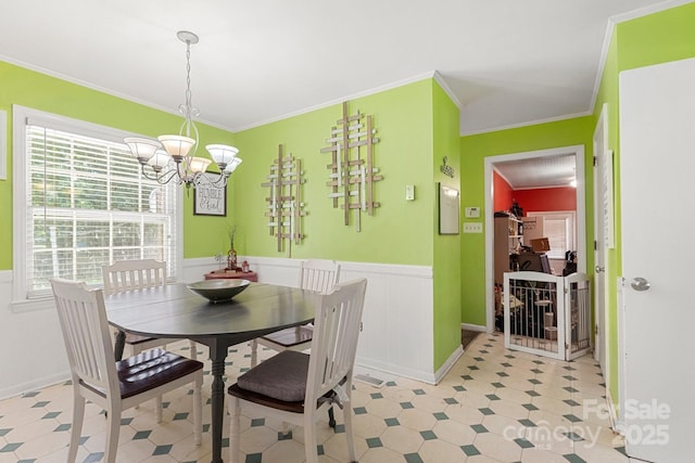 1210 Brookwood Dr, Shelby, NC 28150 - dining space featuring a chandelier, ornamental molding, a wainscoted wall, and light flooring
