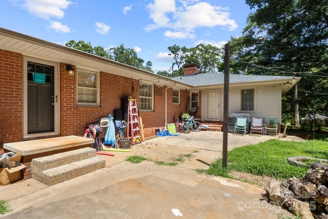 1210 Brookwood Dr, Shelby, NC 28150 - rear view of house with brick siding, a patio, and a chimney