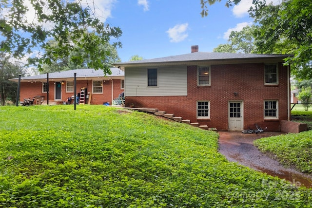 1210 Brookwood Dr, Shelby, NC 28150 - back of property featuring brick siding, a lawn, and a chimney