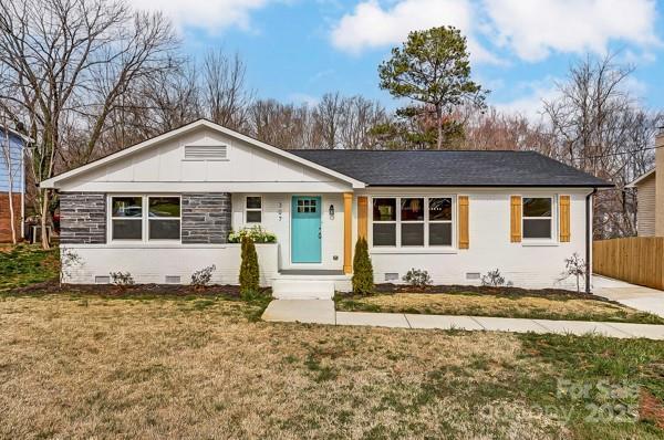 ranch-style house featuring a front yard, crawl space, and fence