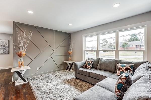 living room featuring recessed lighting, baseboards, and wood finished floors