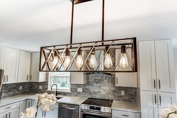 kitchen featuring white cabinetry, tasteful backsplash, and appliances with stainless steel finishes