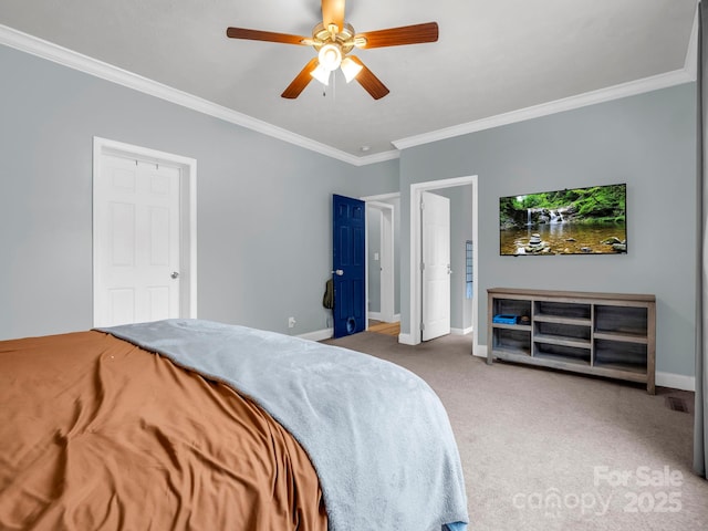 carpeted bedroom featuring baseboards, ceiling fan, and crown molding