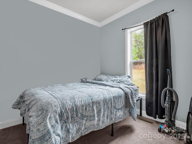 carpeted bedroom with crown molding and baseboards