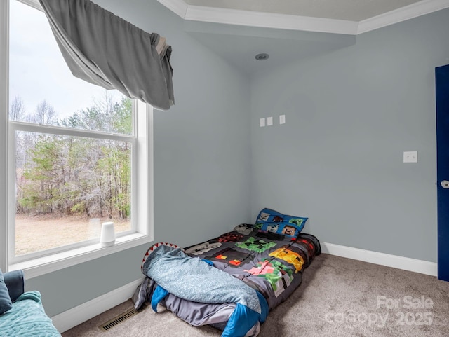 bedroom featuring ornamental molding, carpet, visible vents, and baseboards