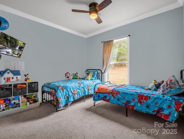 bedroom featuring a ceiling fan, crown molding, and carpet