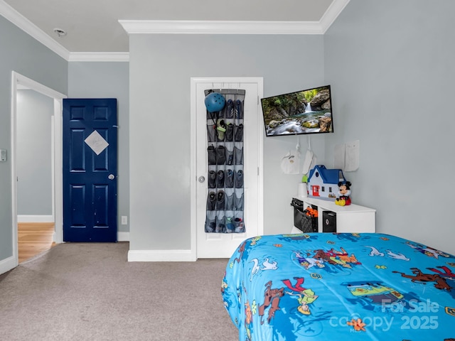 bedroom featuring baseboards, ornamental molding, and carpet flooring