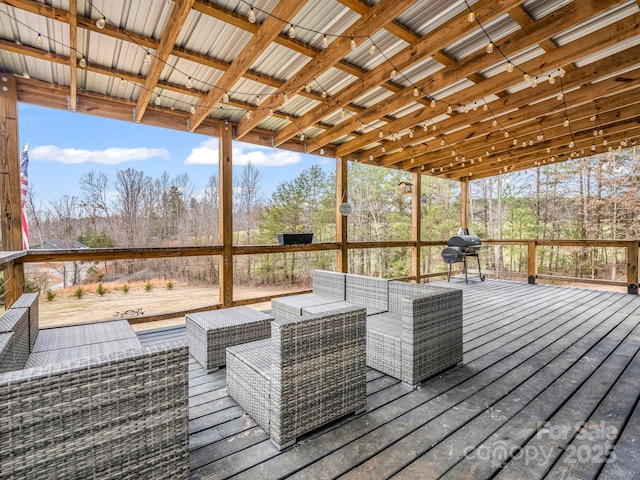 wooden terrace featuring an outdoor living space and a grill