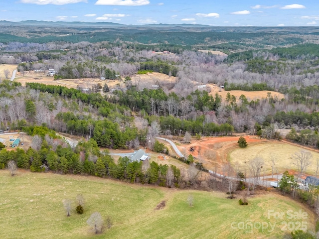 aerial view featuring a mountain view and a forest view