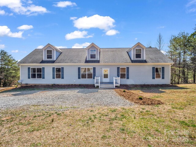 cape cod house with roof with shingles and a front yard