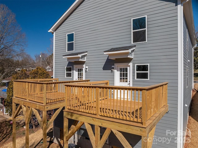 rear view of property featuring a deck