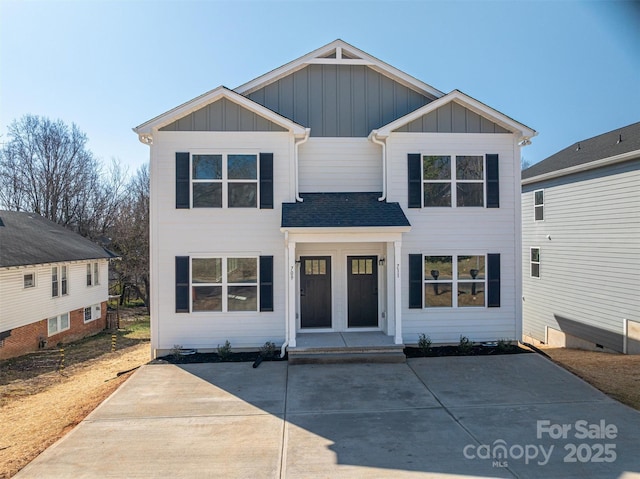 view of front of house with board and batten siding and a shingled roof