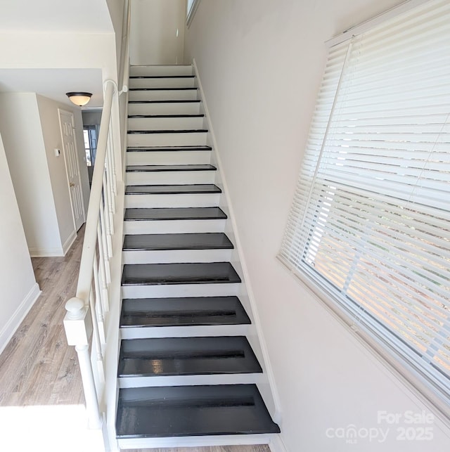 stairs featuring wood finished floors