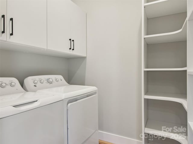 laundry room featuring washer and dryer, cabinet space, and baseboards