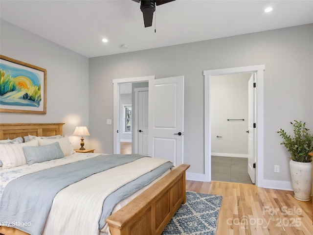 bedroom featuring recessed lighting, light wood-style floors, connected bathroom, ceiling fan, and baseboards