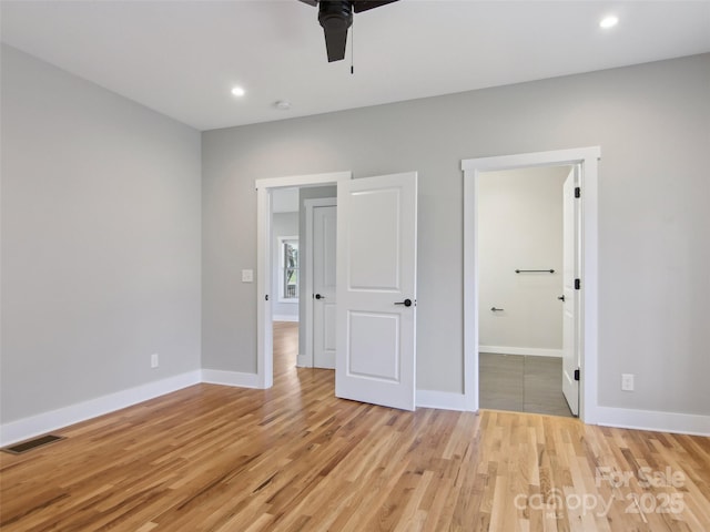 unfurnished bedroom with baseboards, recessed lighting, visible vents, and light wood-style floors