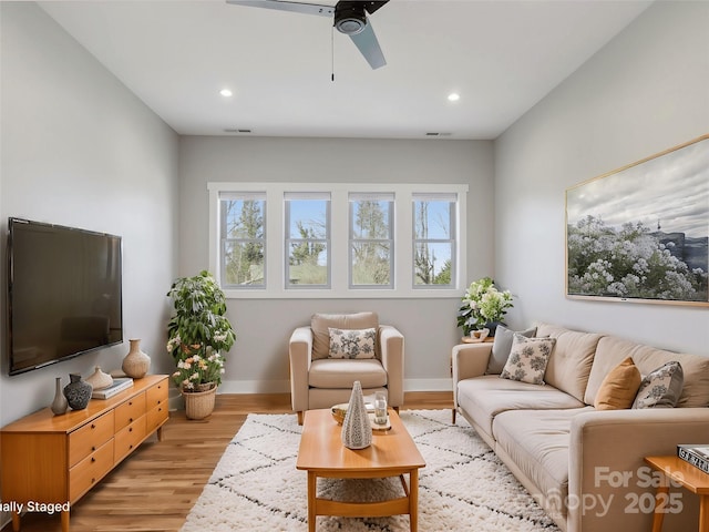 living room featuring light wood-style floors, recessed lighting, baseboards, and a ceiling fan