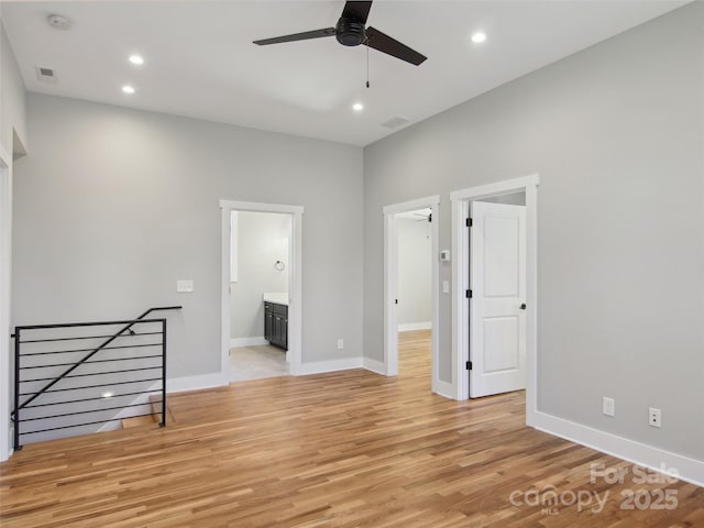 spare room featuring baseboards, visible vents, ceiling fan, light wood-style floors, and recessed lighting