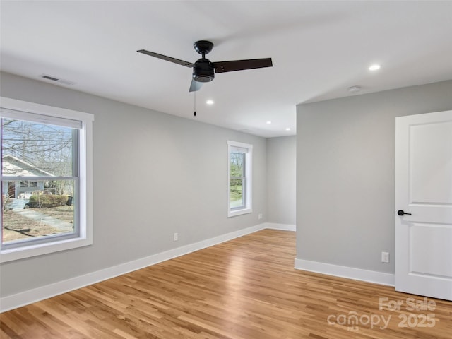 empty room featuring visible vents, recessed lighting, light wood-style flooring, and baseboards