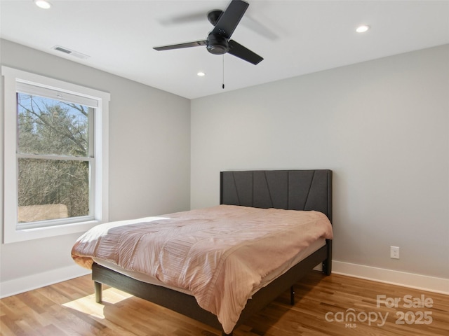 bedroom featuring recessed lighting, visible vents, baseboards, and wood finished floors