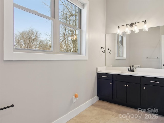 bathroom featuring tile patterned floors, vanity, and baseboards