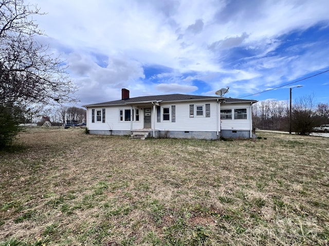 view of front of property with crawl space and a chimney